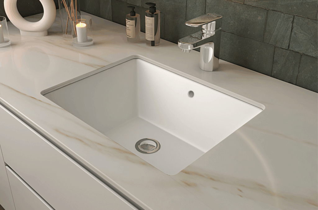 Modern bathroom undercounter basins featuring a sleek, minimalist design with a clean, white vitreous china finish. The basin is paired with a stylish chrome faucet and elegant decor, perfect for contemporary bathroom designs.