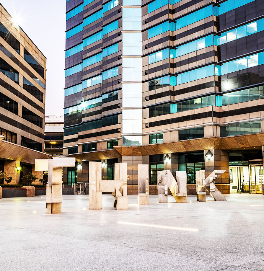 RMB offices in Sandton with modern glass façade and THINK sculpture outside