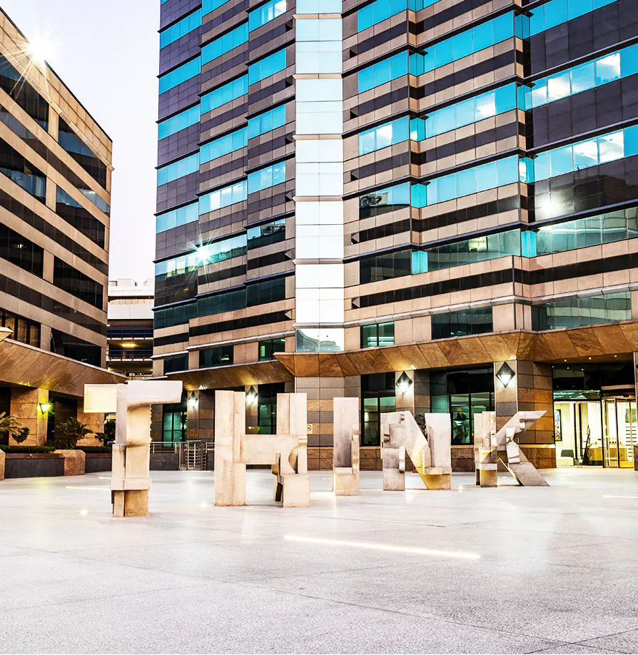 RMB offices in Sandton with modern glass façade and THINK sculpture outside